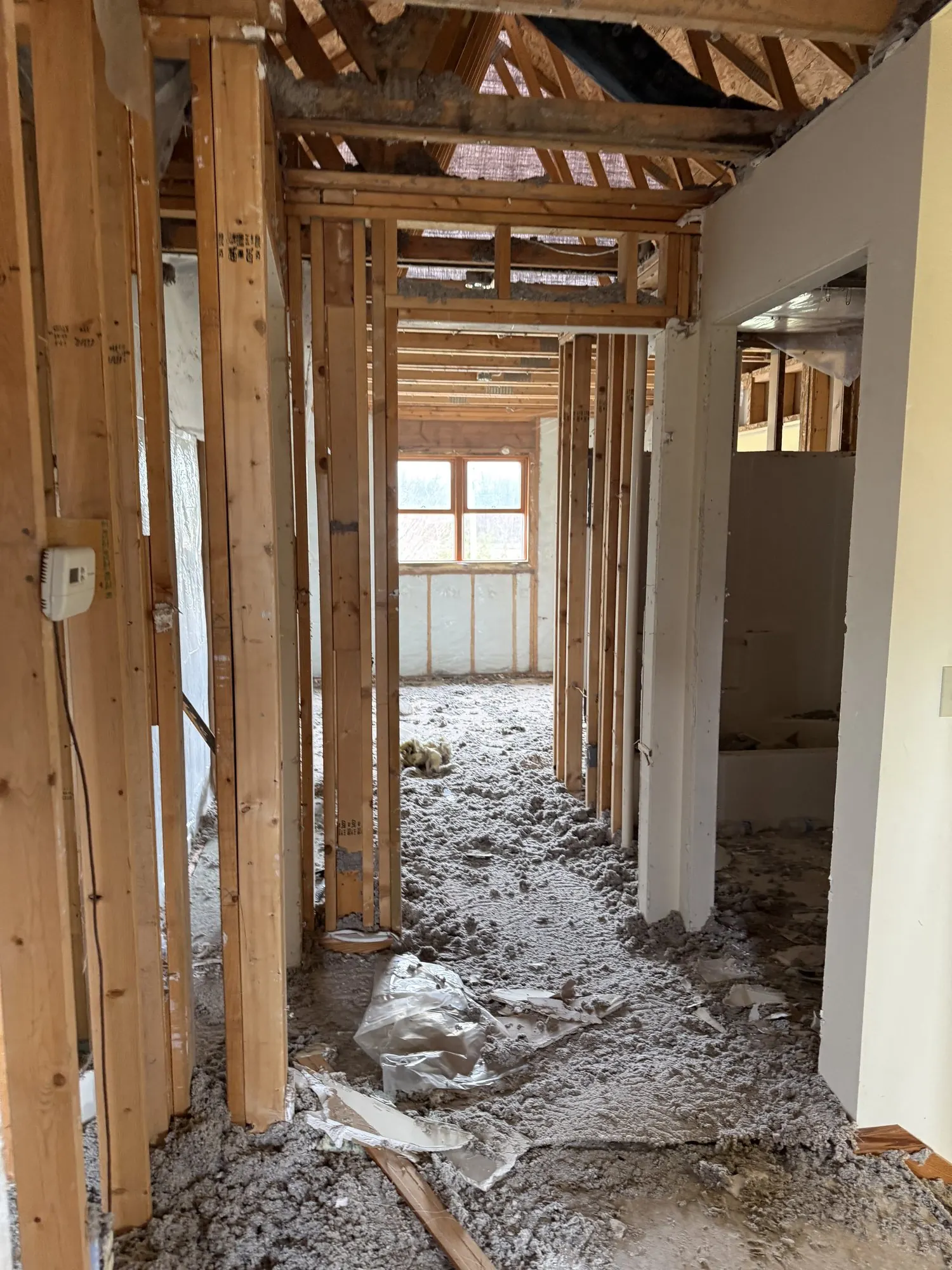 Interior gutted to studs and floor joists during fire restoration.
